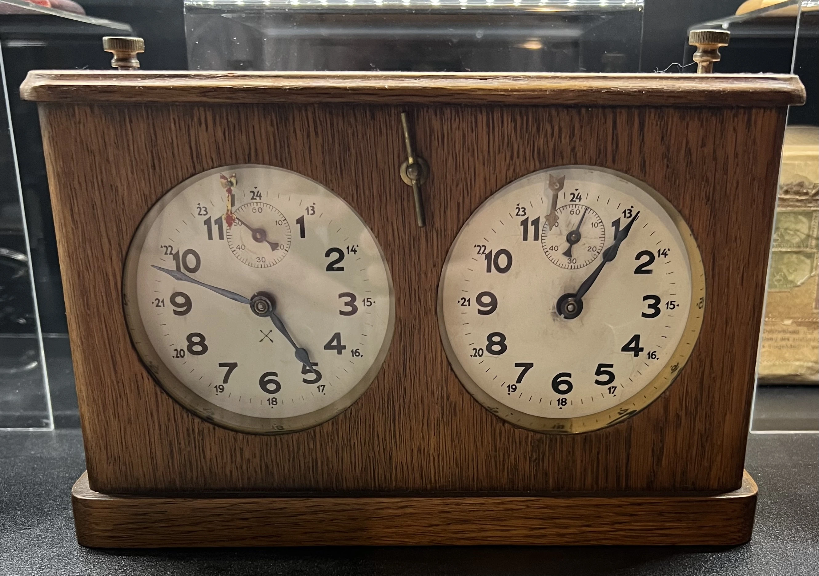 HAC chess clock, front view, with twin dials in a wooden case.