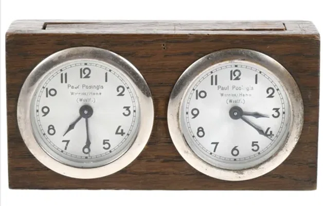 Paul Posingis clock with the maker’s name on its dials.