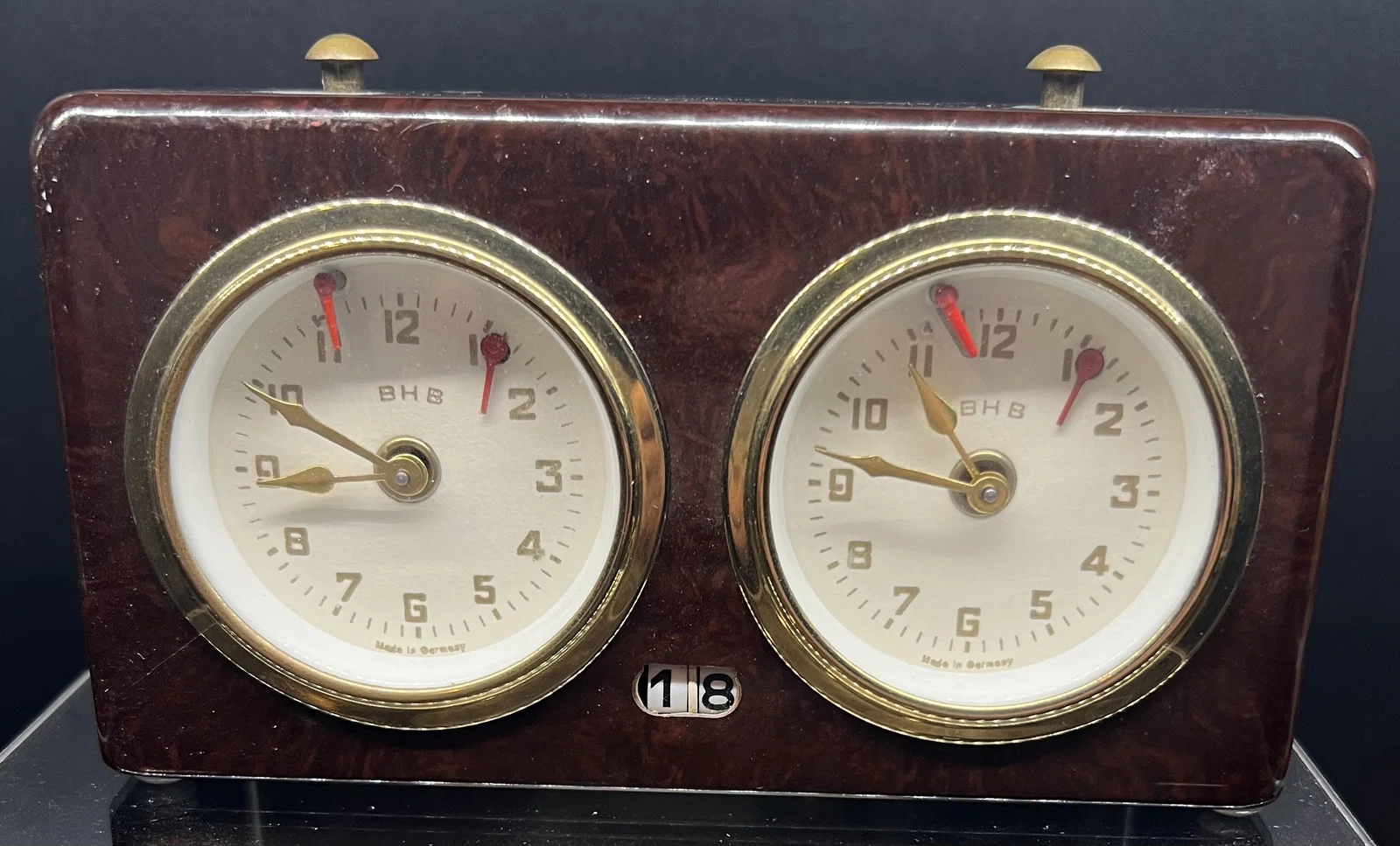 BHB clock with a dark case and brass-colored dial surrounds.
