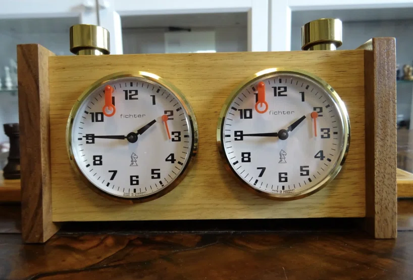 Fichter chess clock with separate round dials in a wooden frame.