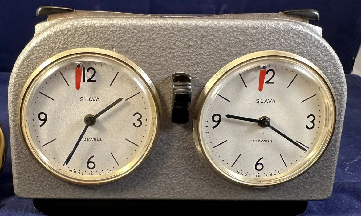 Slava clock with separate round dials and a central control.