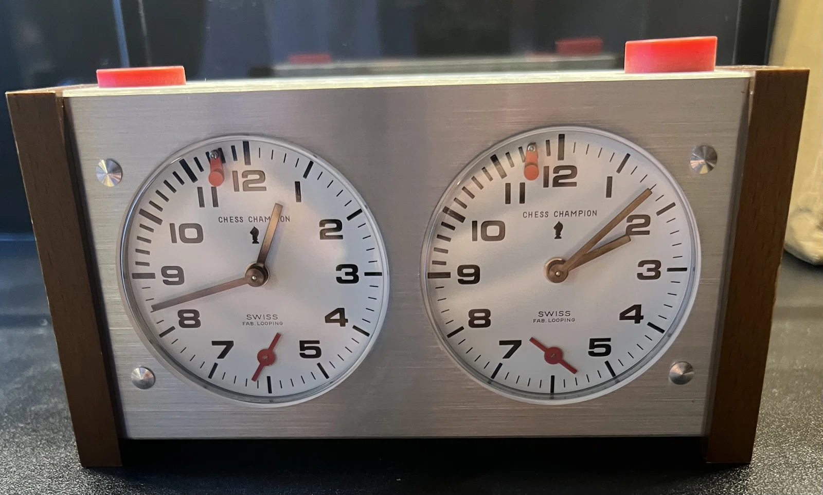 Heuer / Looping clock with red push buttons.