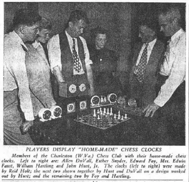Players inspecting home-made all-electric chess clocks